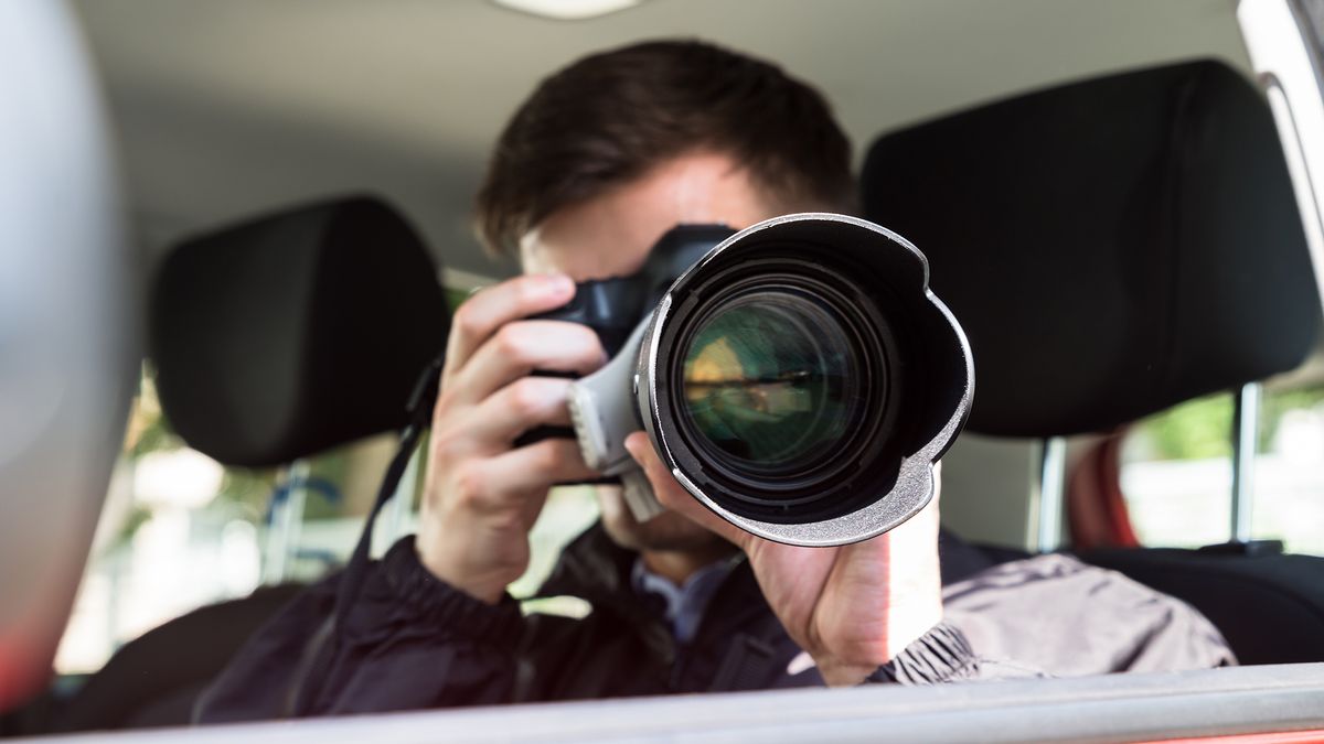 A man taking a photo with a telephoto lens