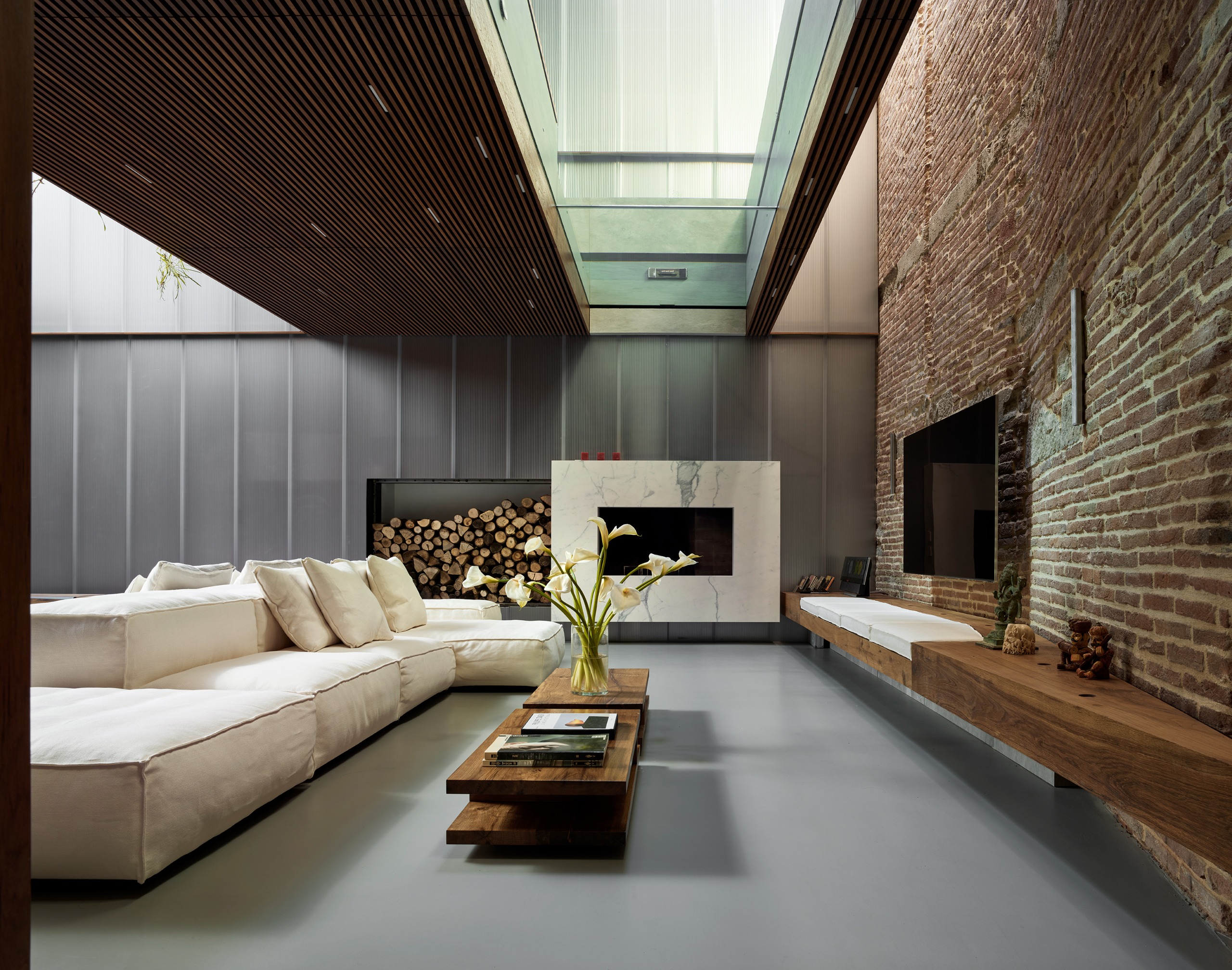 The living space is set beneath the glass-bottomed pool