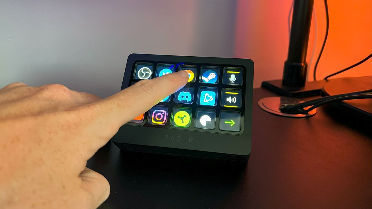 Razer Stream Controller X with the reviewer's hand pressing one of its keys