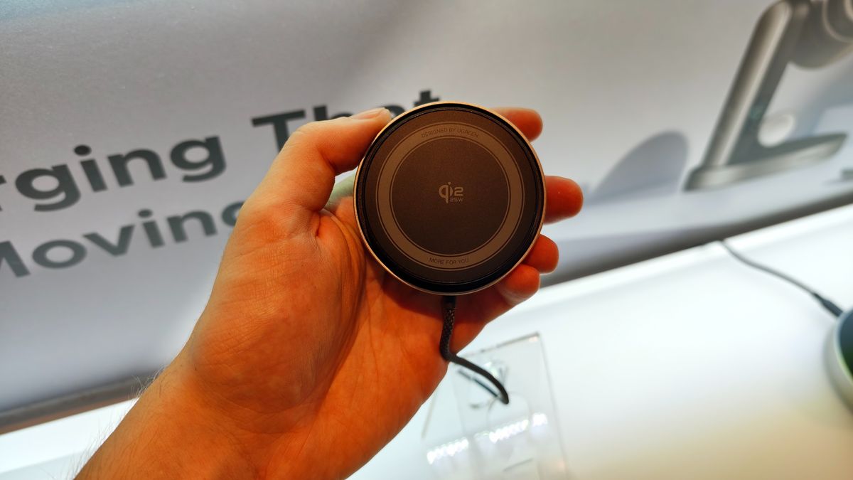 Man holding the MagFlow 2-in-1 Foldable Magnetic Wireless Charger 25W