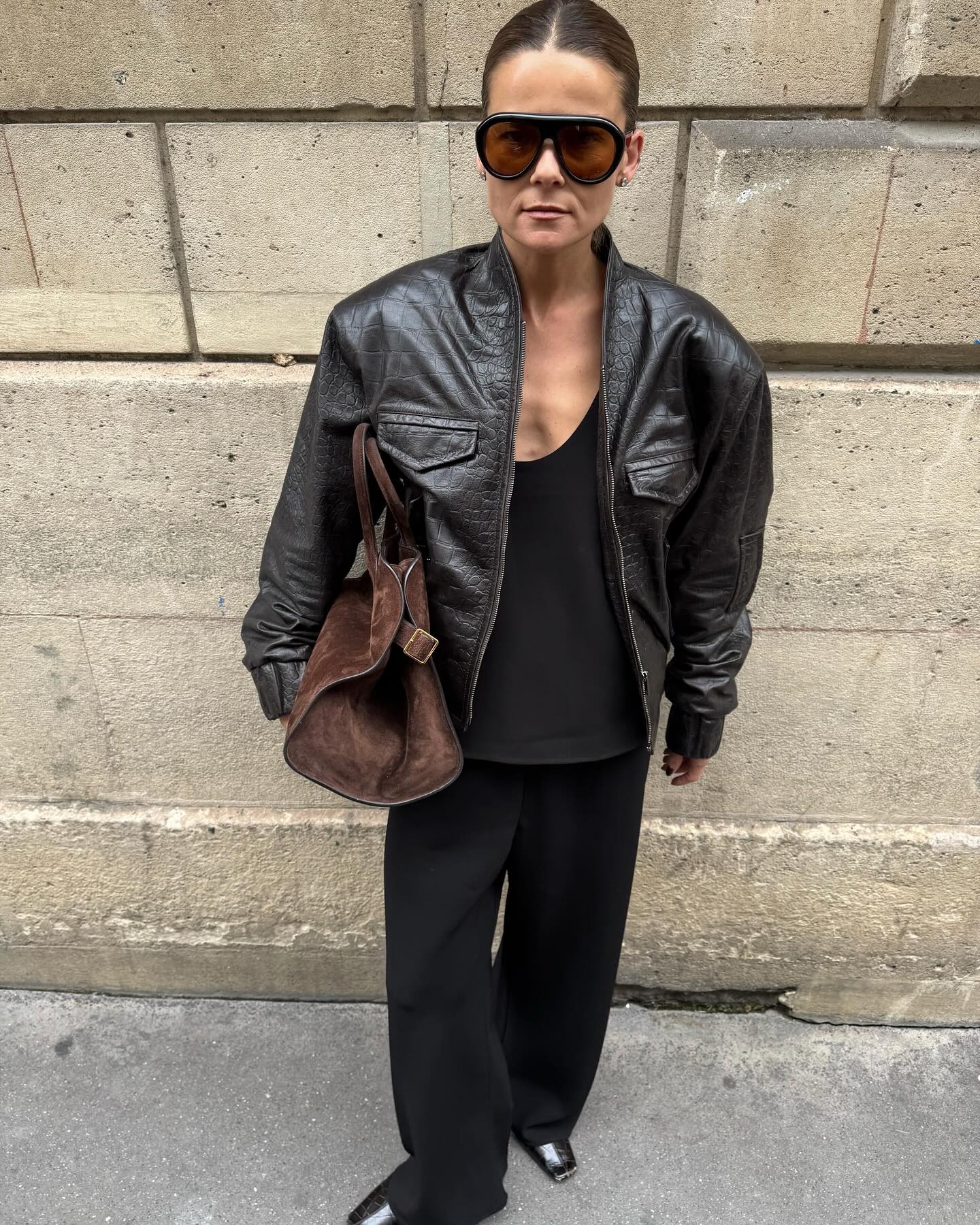 Woman wearing croc jacket, a very big spring 2026 jacket trend.