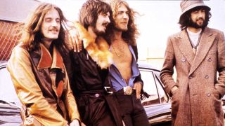 Led Zeppelin leaning against a car