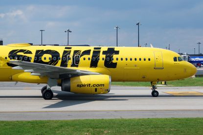 A Spirit Airlines plane on a runway.