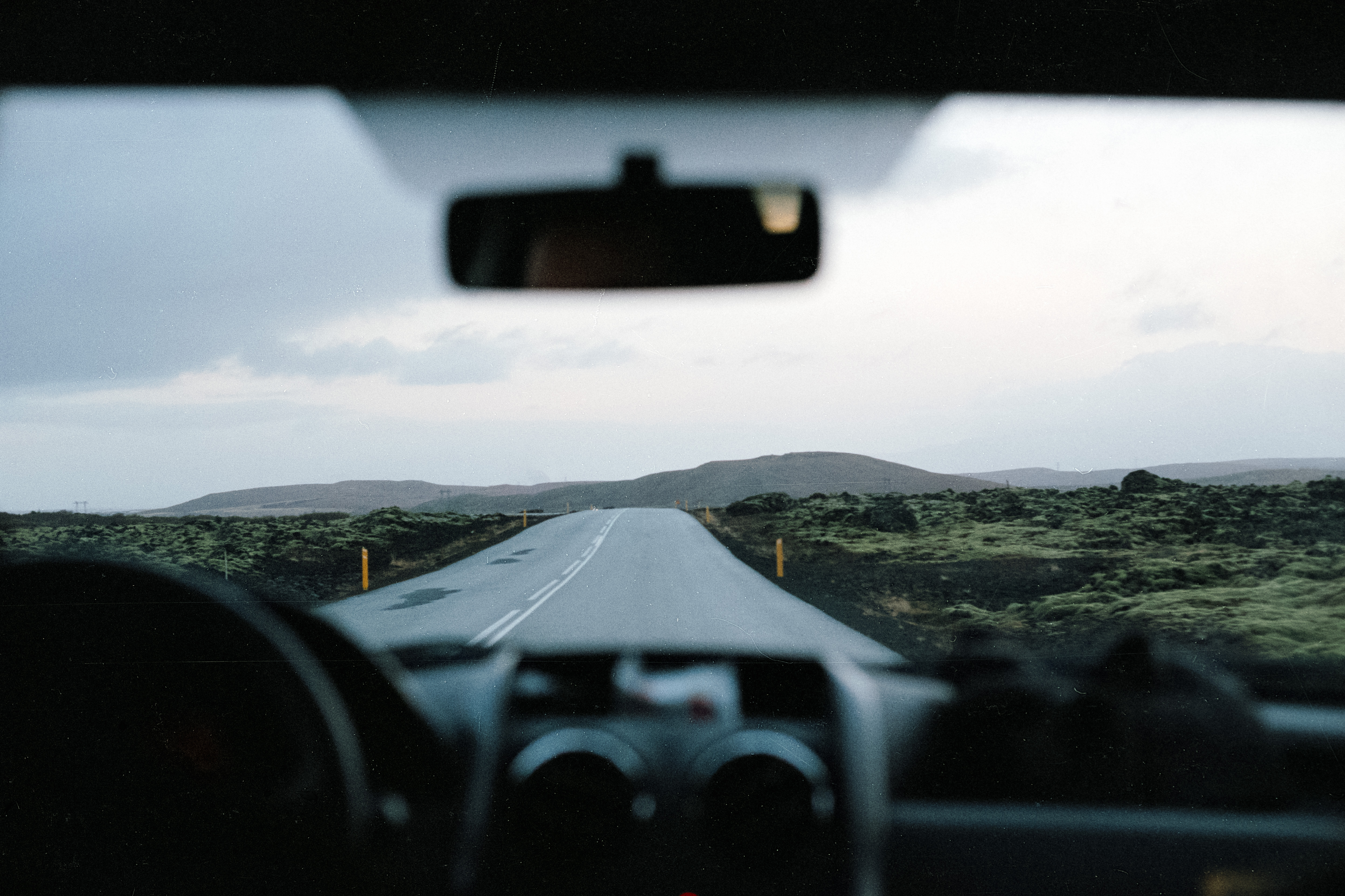View out of a car window driving down a road in rural Iceland