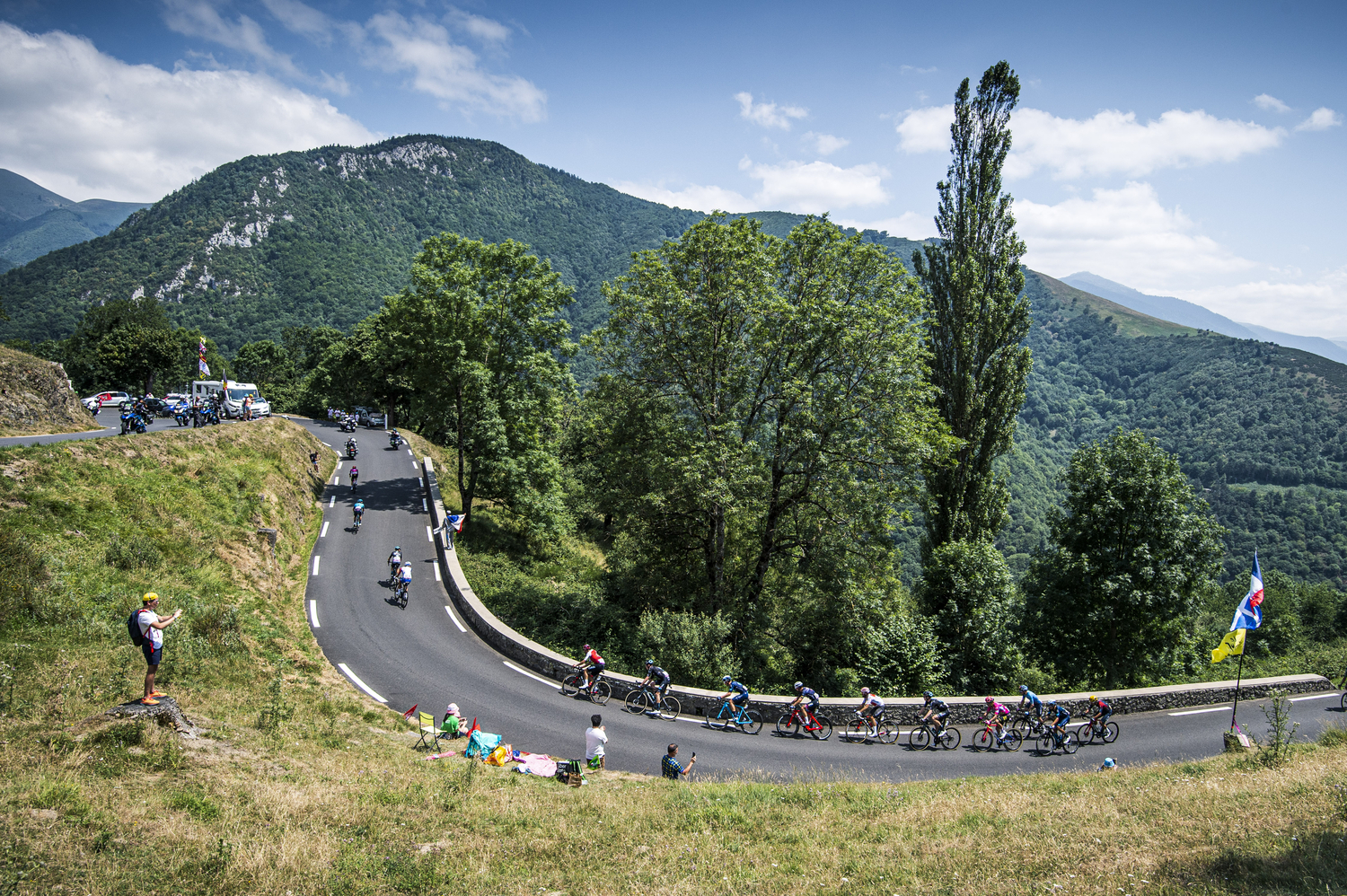 A group of cyclists rounds a hairpin turn on the ascent to Peyragudes - pictured here in 2022