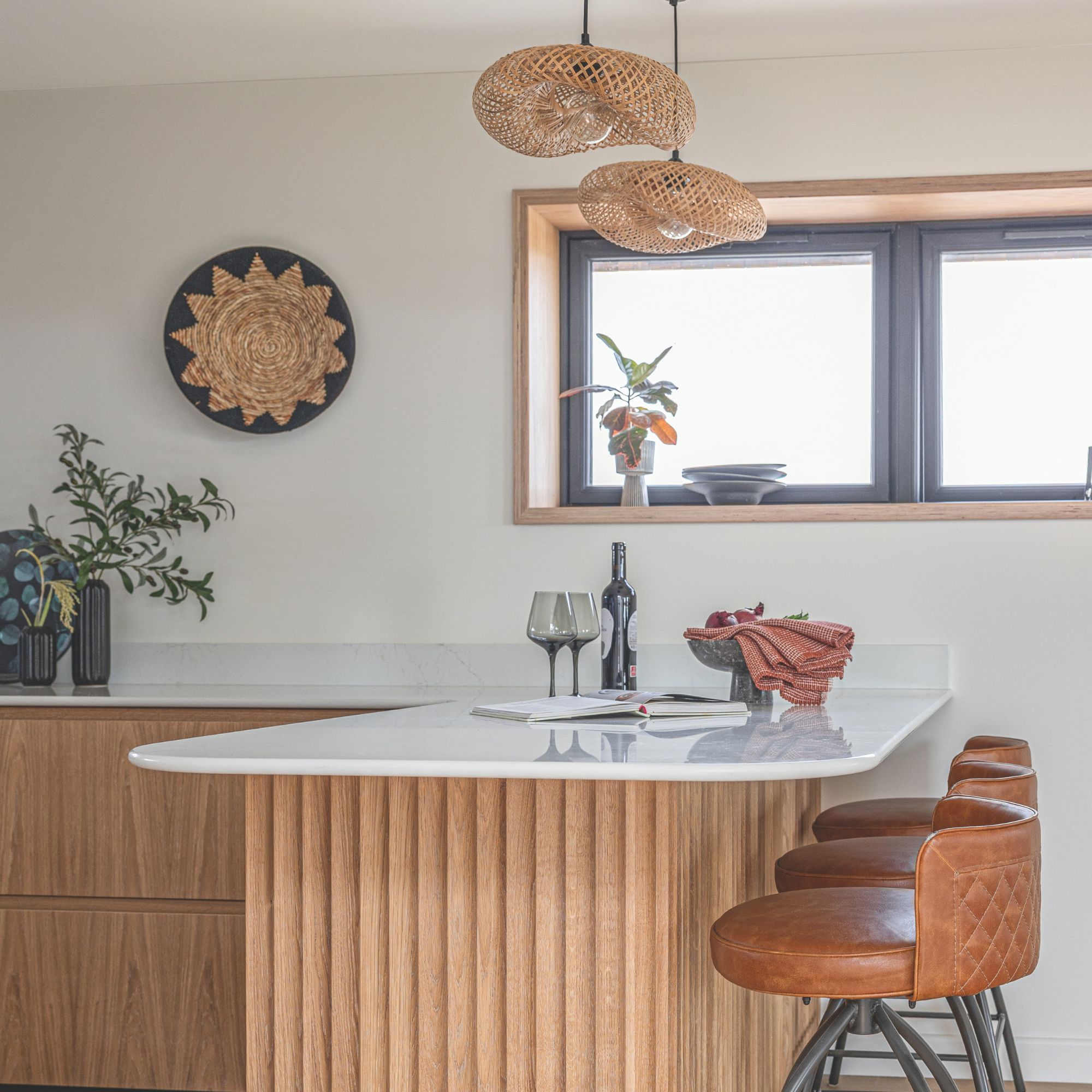 Kitchen island, marble top with wooden ribbed units and brown leather sofas