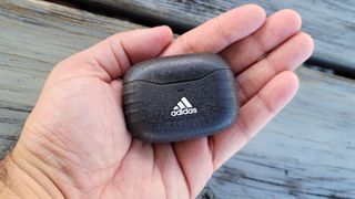 The Adidas Z.N.E. 01 ANC charging case held in hand