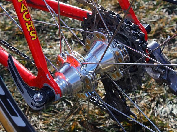 The rear hub features the same cylinder-shaped aluminum spoke anchors plus an alloy freehub body.