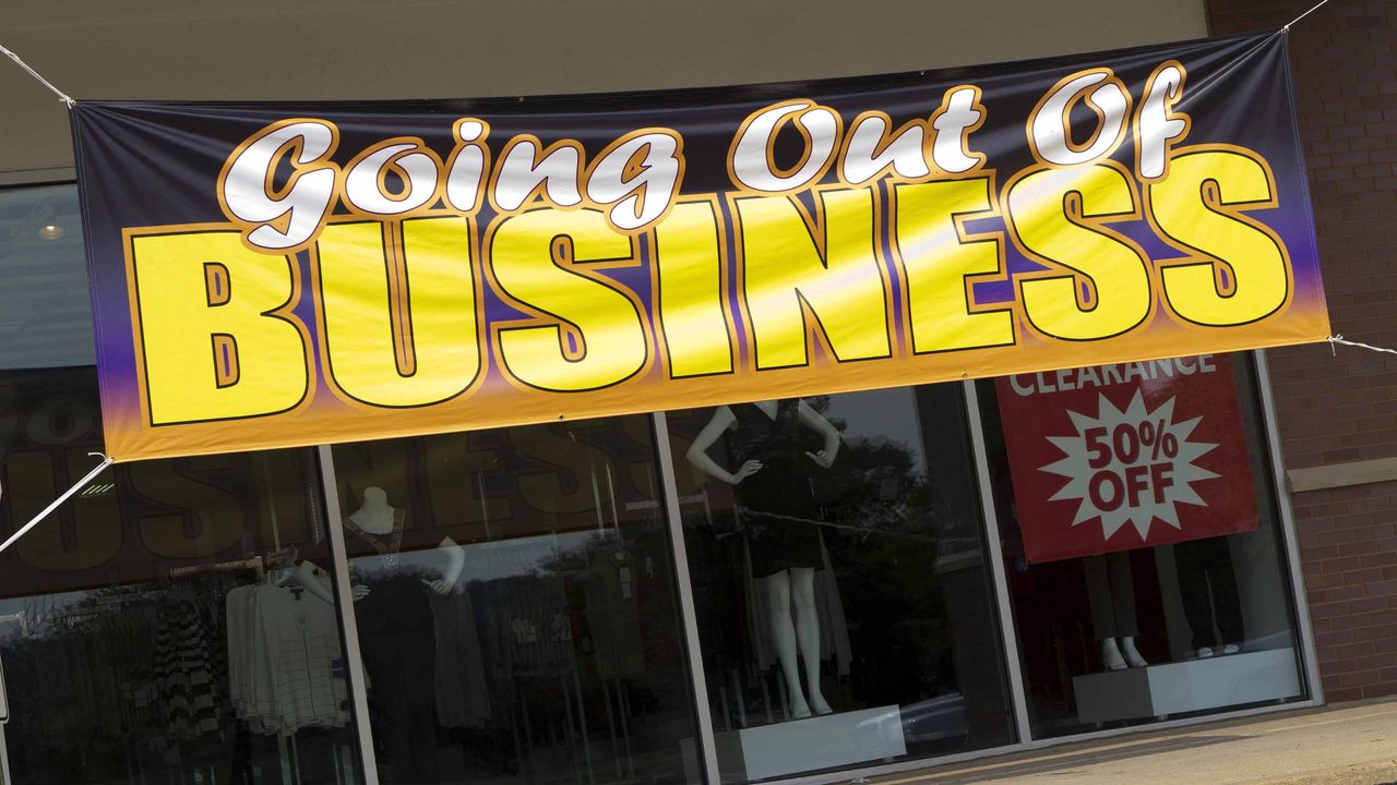 retail store with closing signs on front window