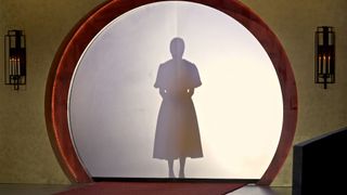 A shadowy figure's silhouette is seen behind a curtain door in Love Is Blind season 2