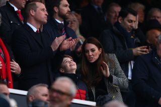 Prince George and Kate Middleton Britain's Prince William, Duke of Cambridge, (L), Britain's Prince George of Cambridge (C) and Britain's Catherine, Duchess of Cambridge, (R) attend the Six Nations international rugby union match between England and Wales at Twickenham Stadium, west London, on February 26, 2022. (Photo by Adrian DENNIS / AFP) (Photo by ADRIAN DENNIS/AFP via Getty Images)