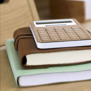 calculator and notebooks on table