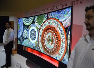 The world’s first curved television – the LG Curved Ultra 108-inch HD TV – guarded by LG employees after being unveiled at CES 2014.