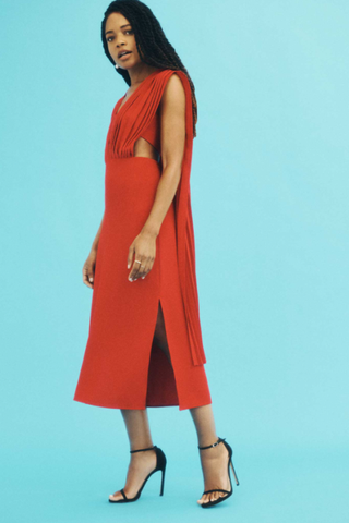 naomie wearing red midi dress with cape detail