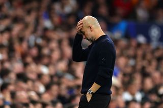 Pep Guardiola, Manager of Manchester City, looks dejected during the UEFA Champions League 2024/25 League Knockout Play-off second leg match between Real Madrid C.F. and Manchester City at Santiago Bernabeu Stadium on February 19, 2025 in Madrid, Spain.