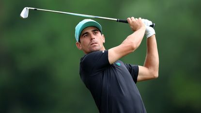 Joaquin Niemann holds his finish on an iron shot