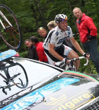Jens Voigt (Saxo Bank) amongst team cars at the Tour of Slovenia