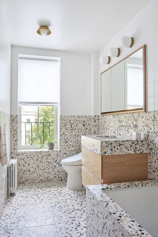 A terrazzo bathroom brings splashes of pale pink and blue