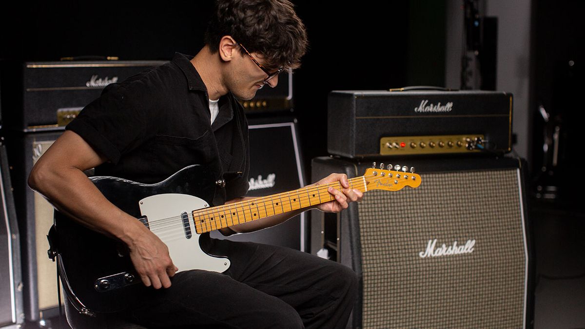 A photograph of Press To Meco with guitars and amps