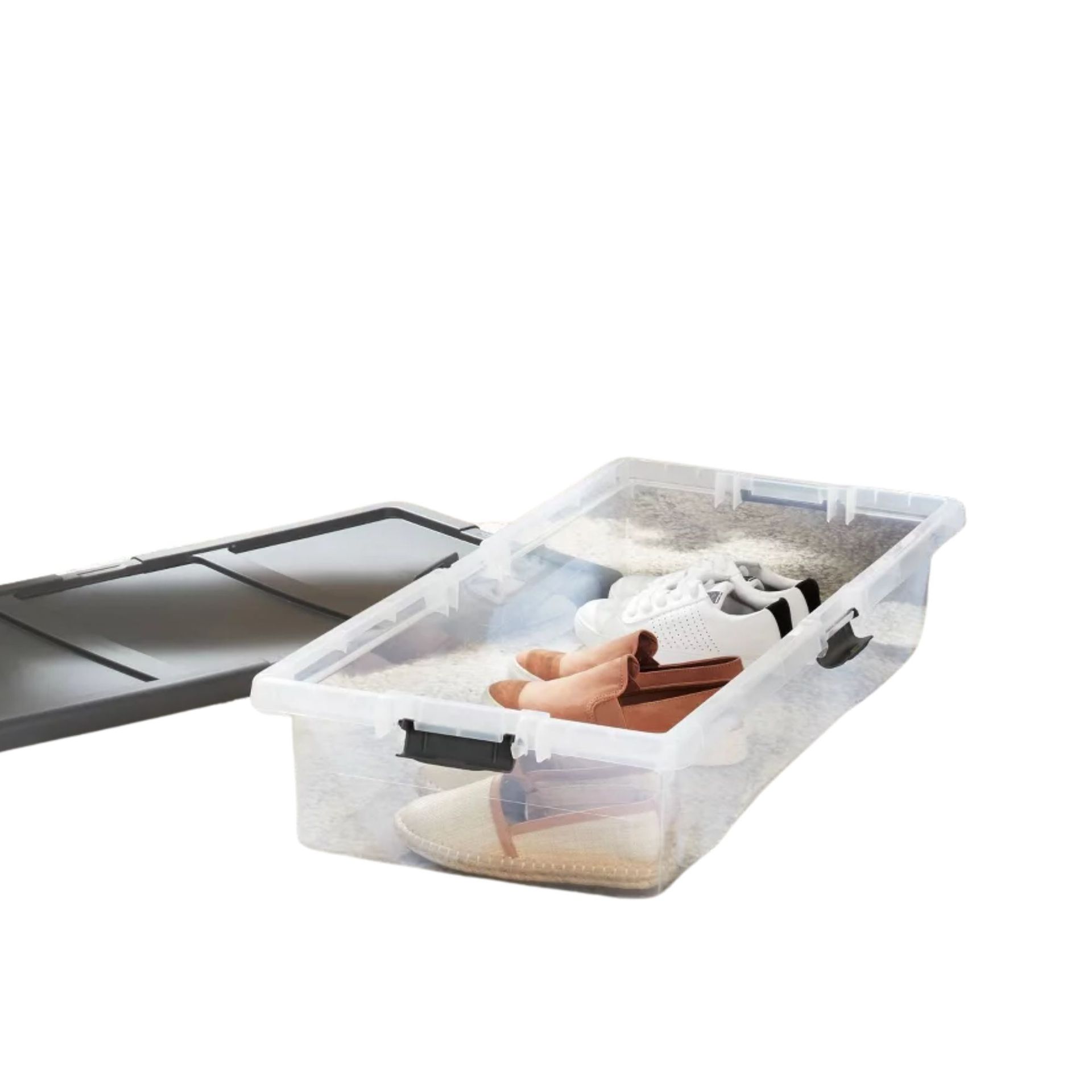 A clear under-bed storage box with shoes inside of it and a gray lid to the left of it