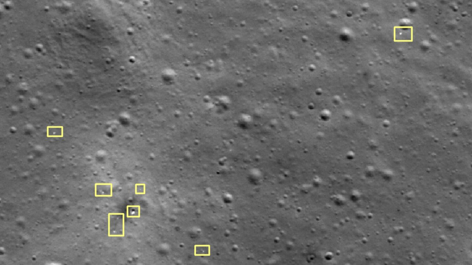 Satellite image of the moon with several yellow boxes showing where debris is located
