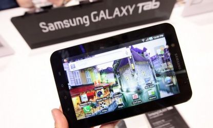 Visitors try out the new Samsung Galaxy Tab, a product that has features and looks similar to the Apple iPad.