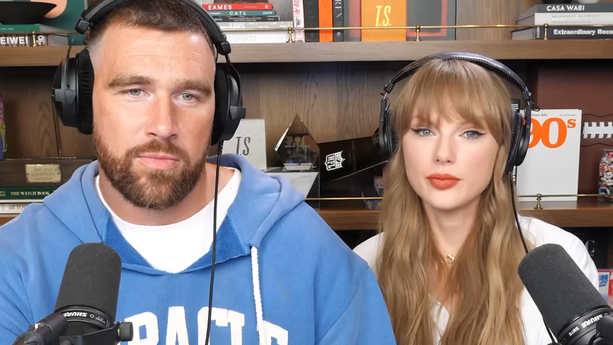 Travis Kelce and Taylor Swift look unimpressed as they record a New Heights episode.