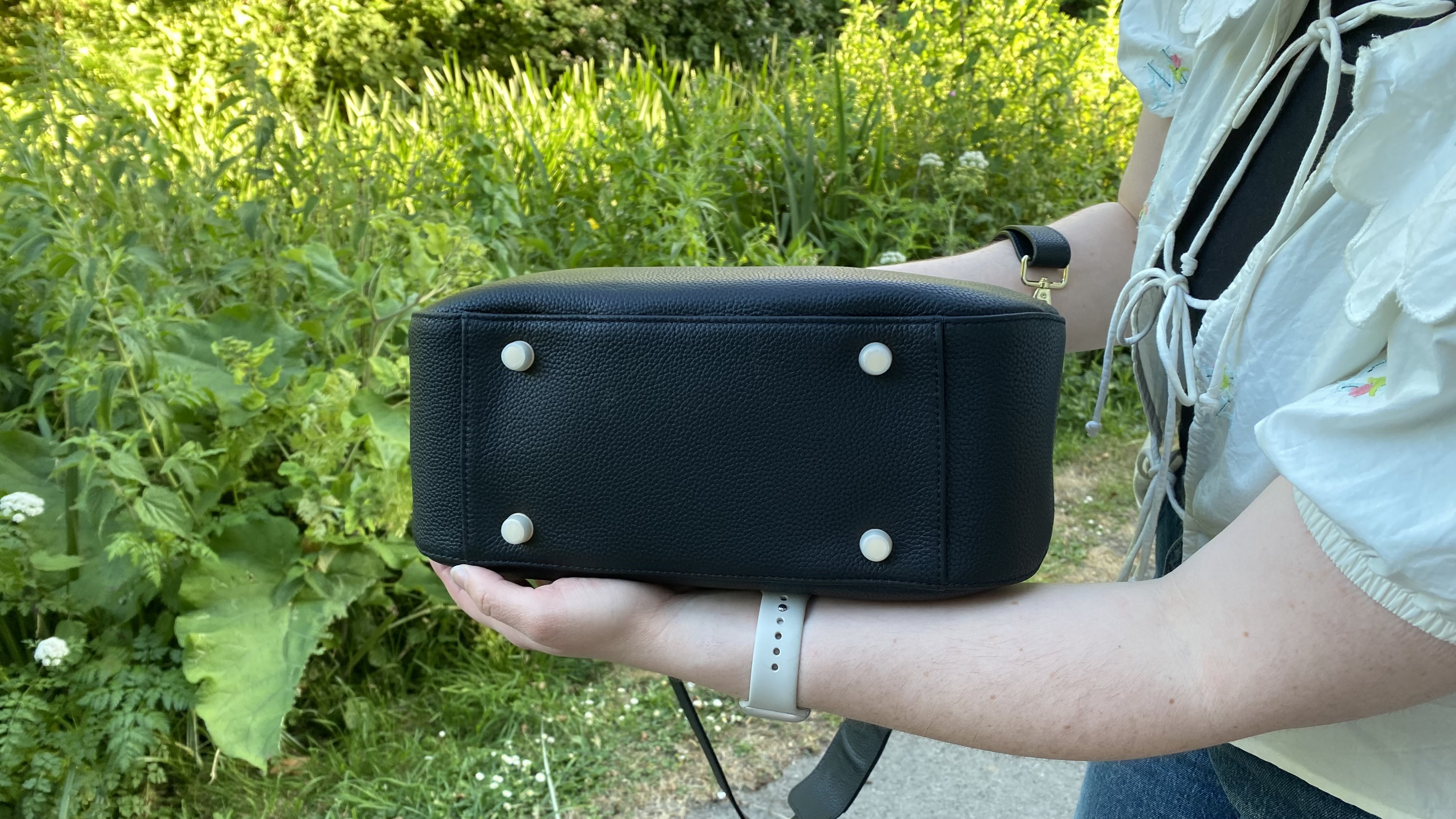 Person showing underside of Voygr 1 camera bag