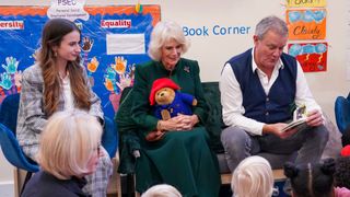 Camilla, Queen Consort with Madeleine Harris (L) and Hugh Bonneville (R) attend a special teddy bears picnic at a Barnardo's Nursery in Bow on November 24, 2022 in London, England. During the visit The Queen Consort personally delivered Paddington bears and other cuddly toys that were left as tributes to Queen Elizabeth II to children supported by the charity. In 2016, Her Majesty Queen Elizabeth II passed the patronage of Barnardo's to the then Duchess of Cornwall.