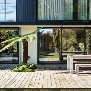 Exterior of back of house with floor-to-ceiling glass sliding doors