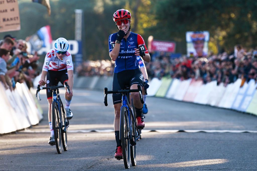 BERGEN NETHERLANDS NOVEMBER 13 Shirin Van Anrooij of The Netherlands and Team TrekLions R celebrates at finish line as race winner ahead of Fem van Empel of The Netherlands and Team Pauwel Sauzen Bingoal L during the 1st UCI Cyclocross World Cup Beekse Bergen 2022 Womens Elite CXWorldCup BeekseBergen Cyclocross on November 13 2022 in Bergen Netherlands Photo by Luc ClaessenGetty Images
