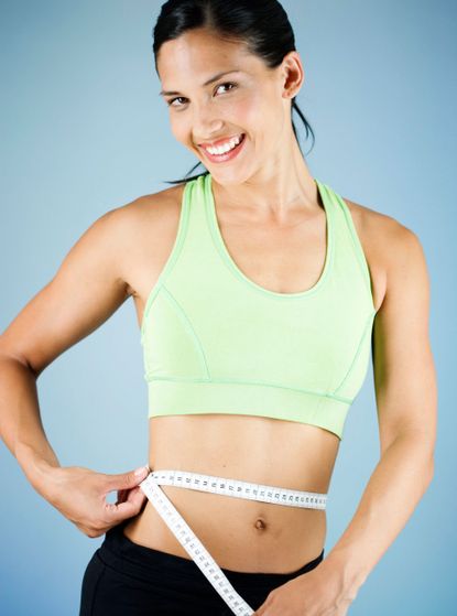 woman measuring waist photo