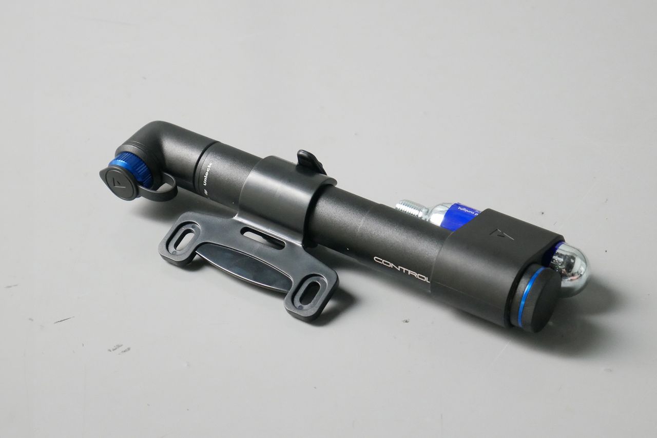 Best bike mini pumps group test 2026 - Giant Contact Go in black/blue set to a grey background with its mount and CO2 carrier attached