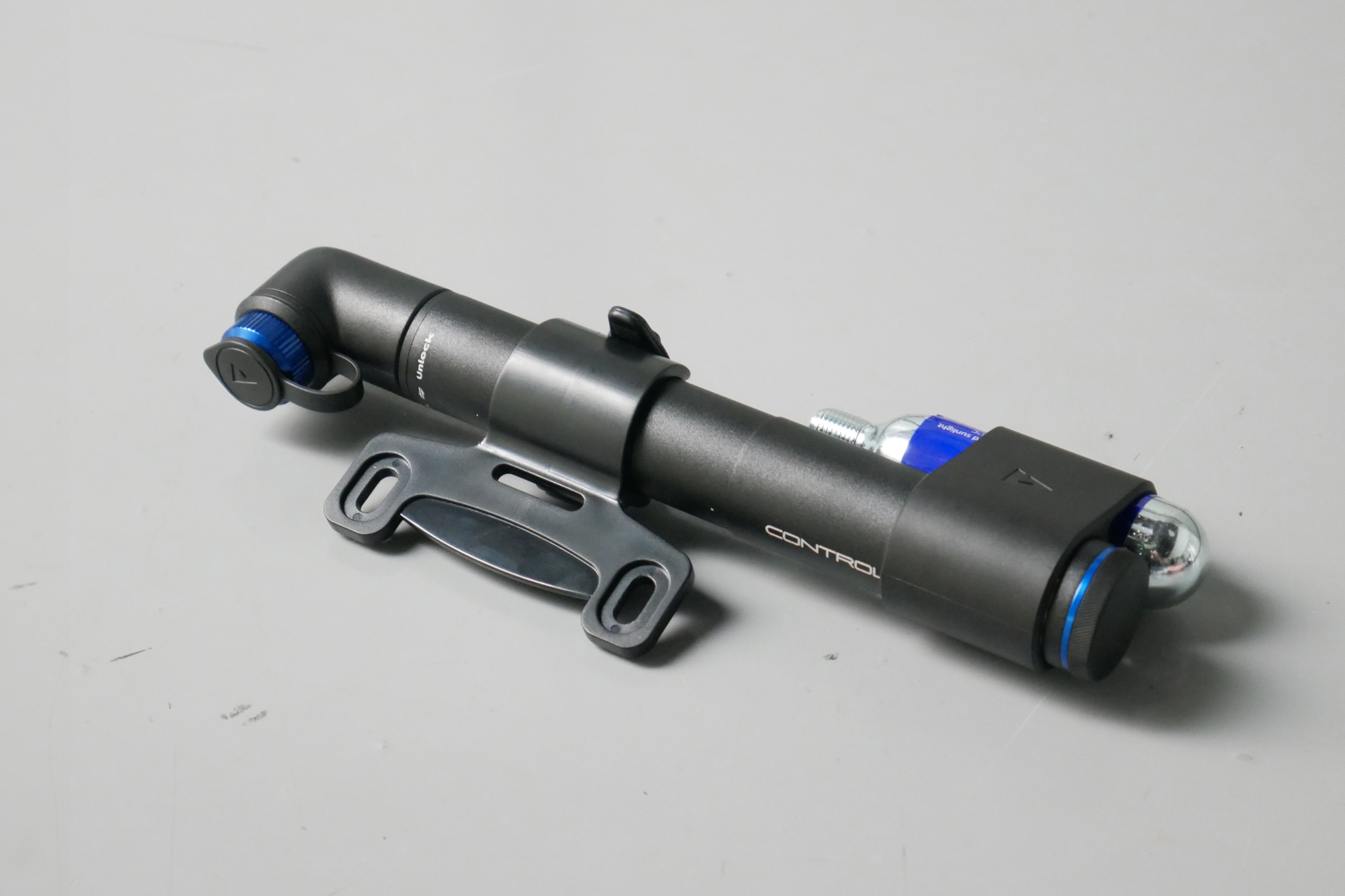 Best bike mini pumps group test 2026 - Giant Contact Go in black/blue set to a grey background with its mount and CO2 carrier attached