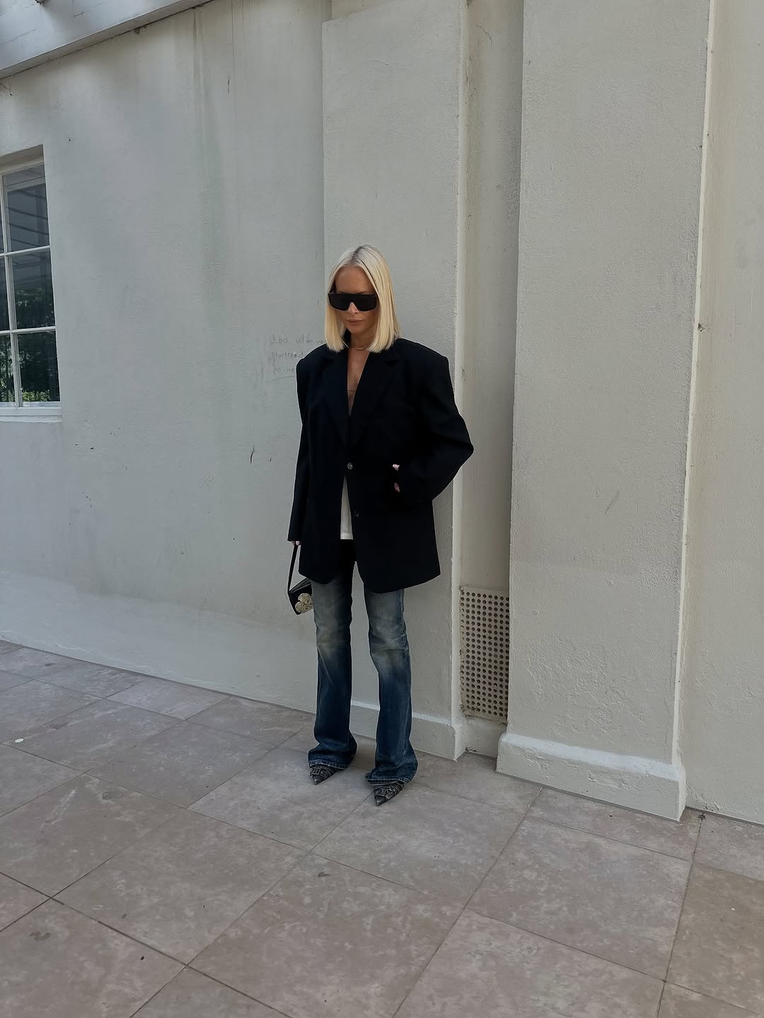 woman wearing dirty denim wash jeans fall denim trend 2025