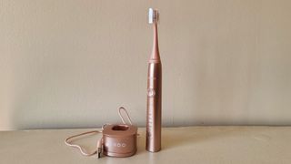 Ordo Sonic+ Electric Toothbrush and a charger on a bathroom shelf