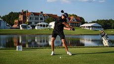 Mac Boucher strikes a drive in front of the East Lake clubhouse