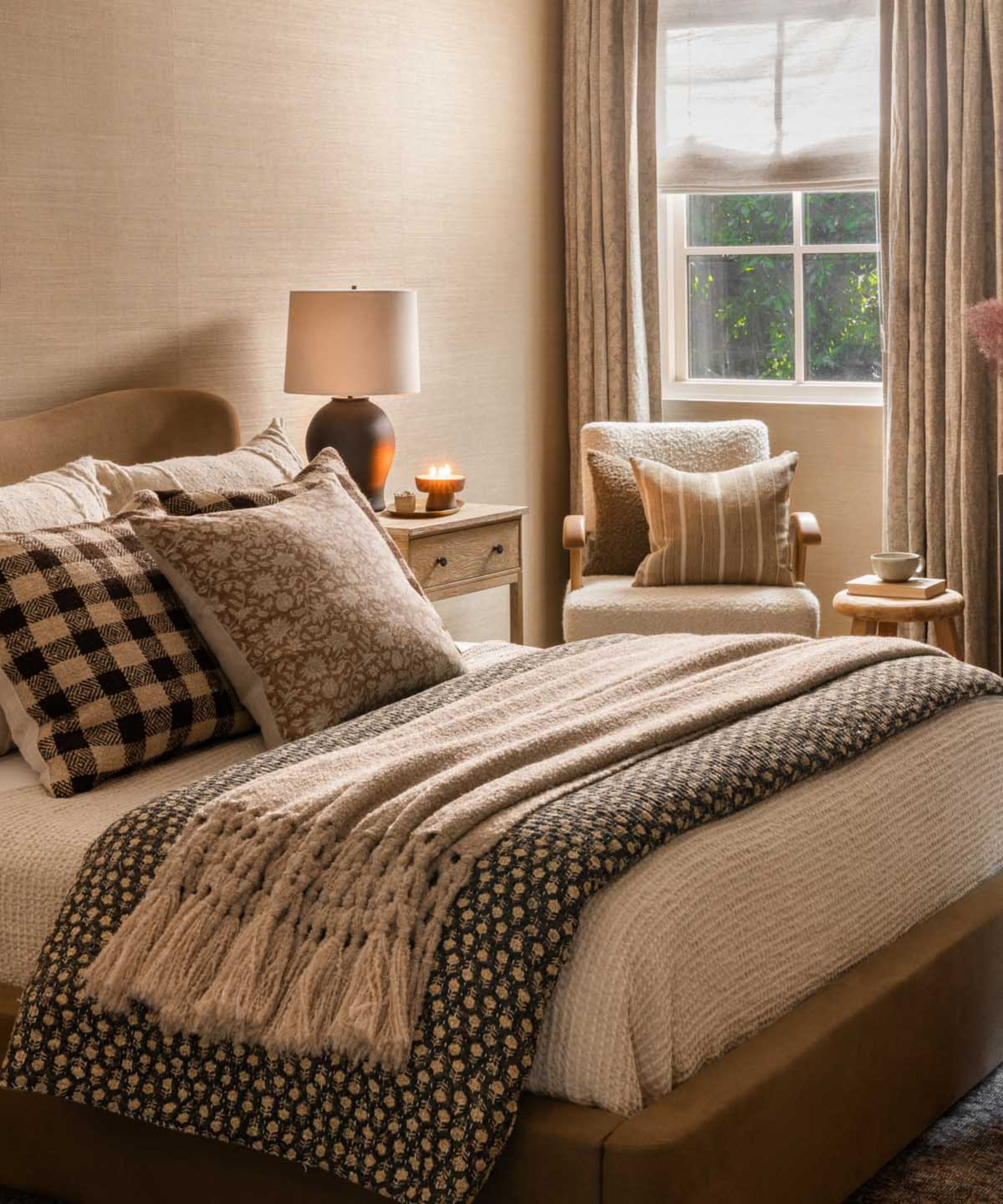 a bedroom with a bed with mixed prints and patterns