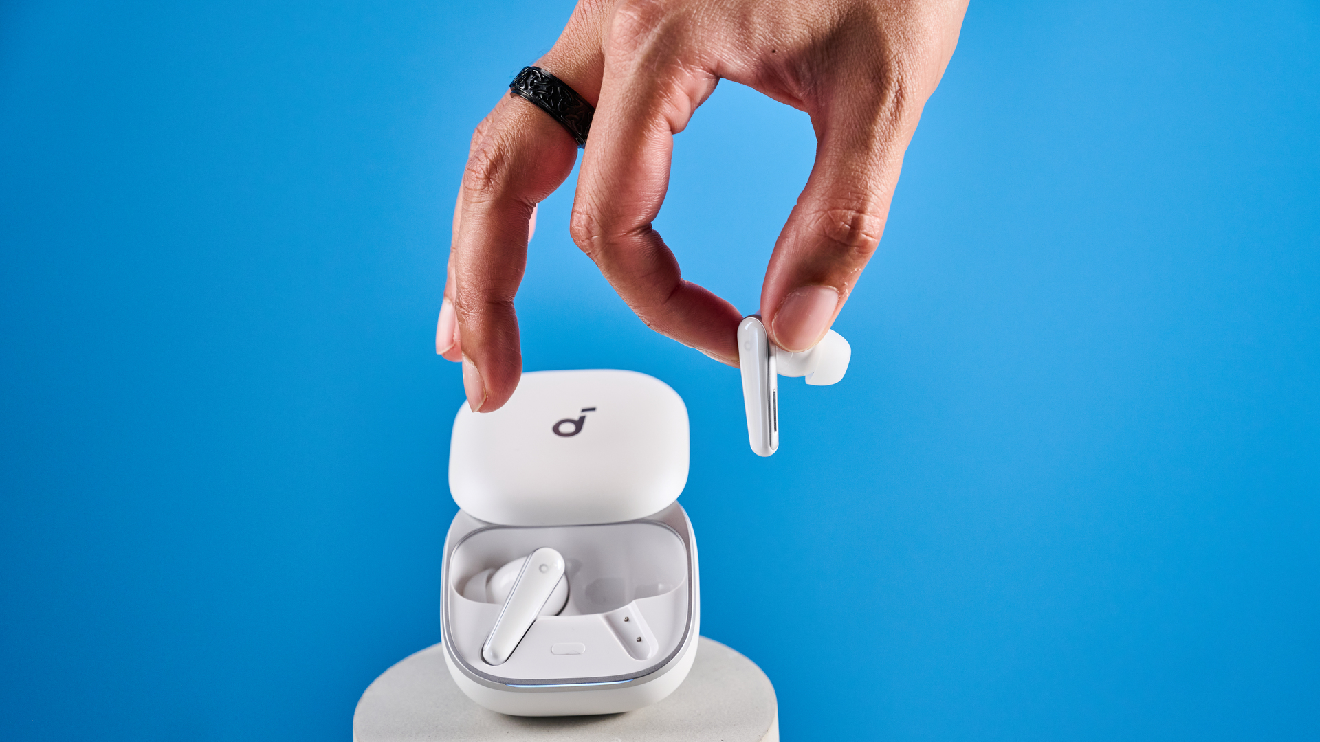 The Soundcore Liberty 5 photographed in front of a blue background.