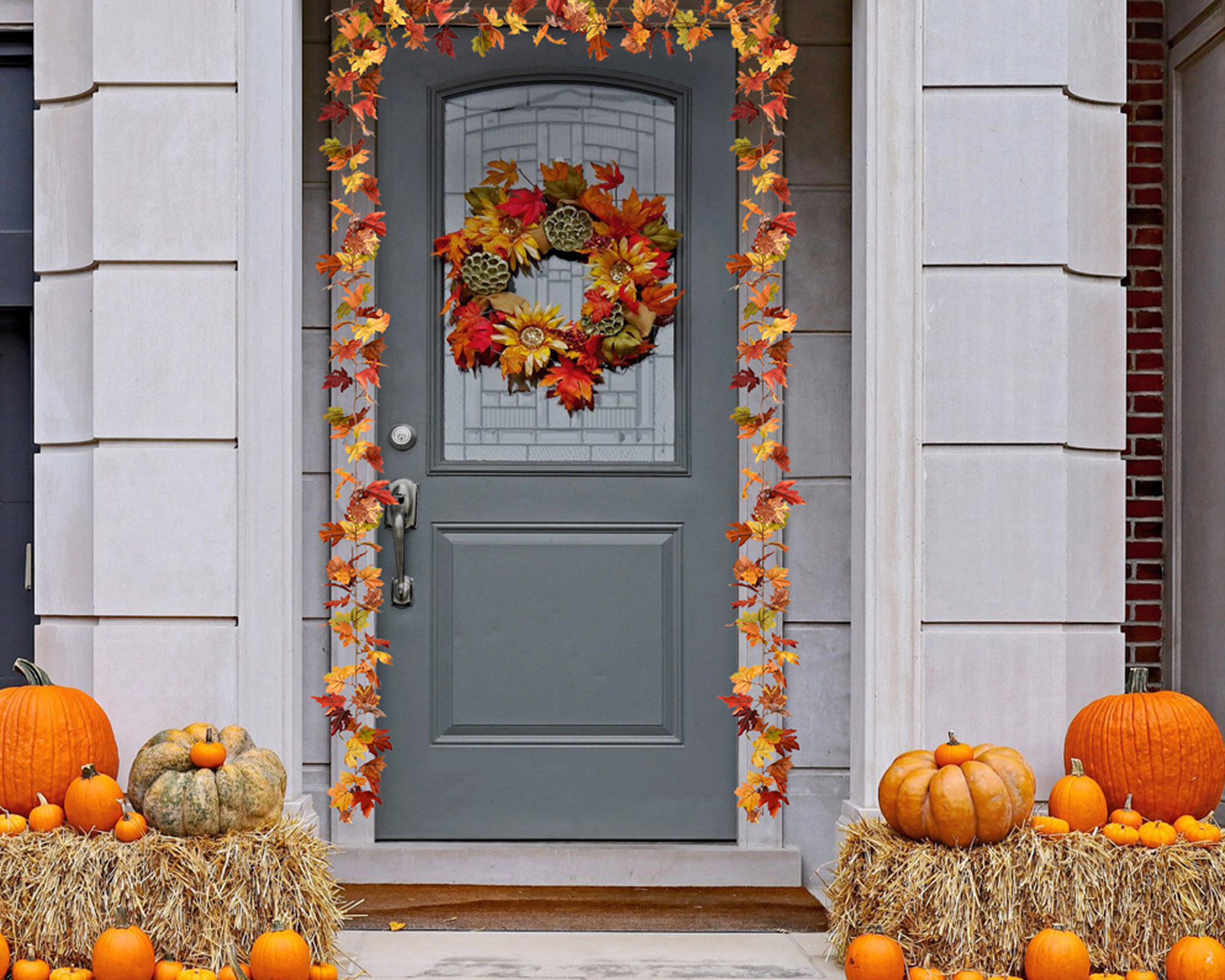 Fall leaf garland around door and wreath with pumpkins and hay bales - walmart