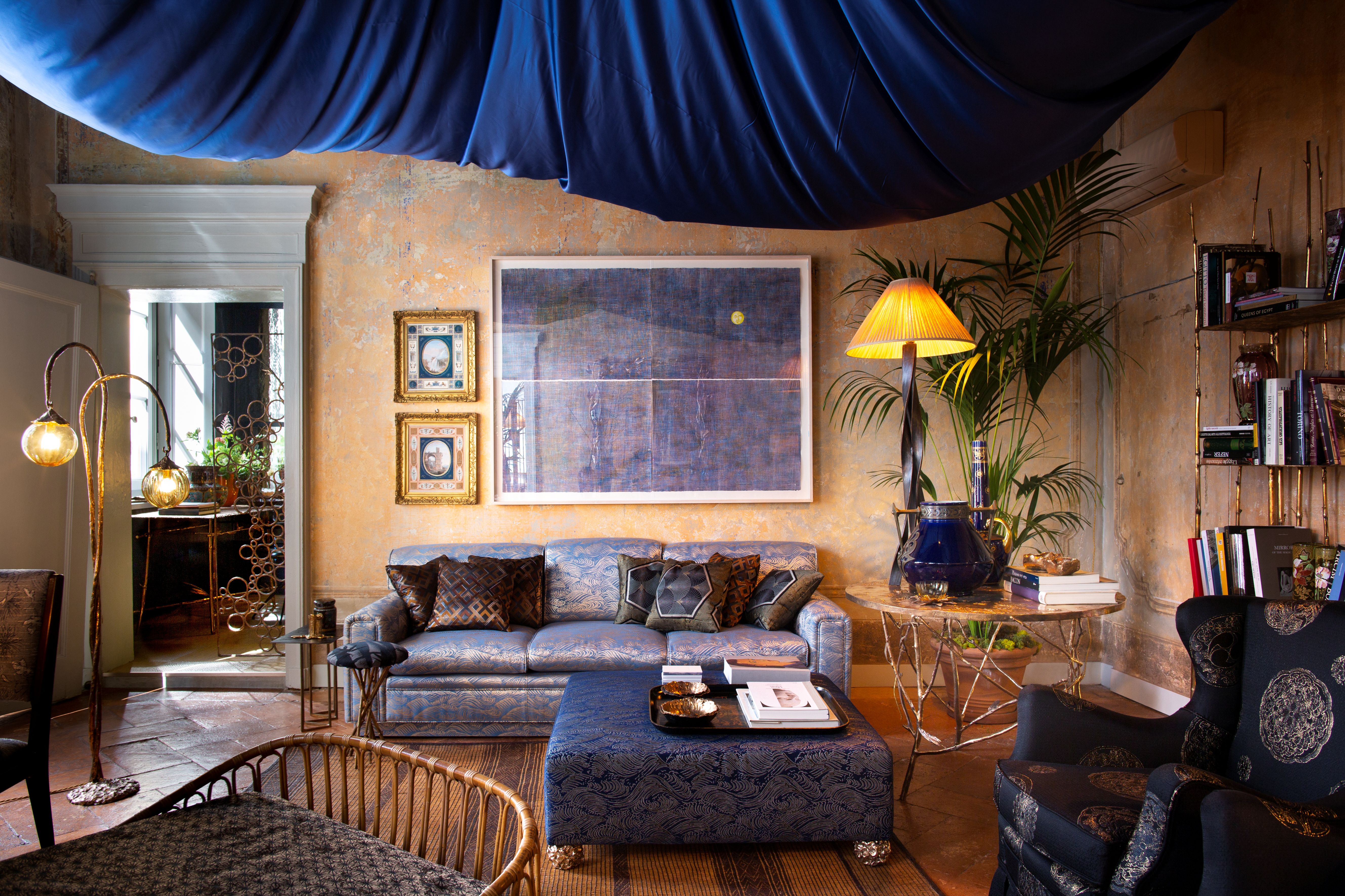 a living room with a large voluminous blue fabric draped across the ceiling