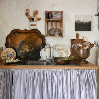 sink area with sink skirt in a utility in an old country cottage