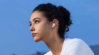 Woman wearing 1More PistonBuds Pro Q30 earbuds.