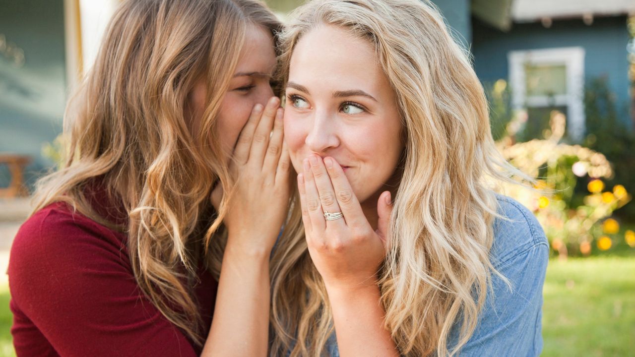 Two young women confessing secrets 