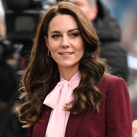 Princess Kate wears a wine red suit with a pink blouse while making an official visit in boston