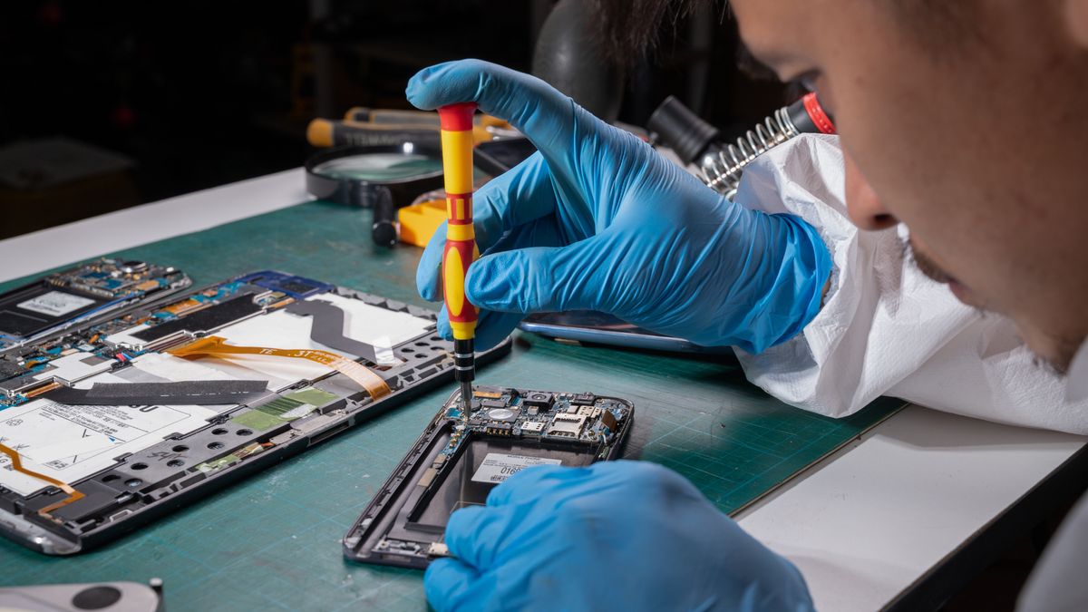 A person repairing an iPhone