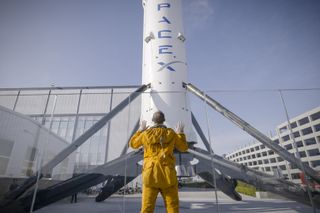 "Everyday Astronaut" Tim Dodd beholds a landed Falcon 9 first stage and SpaceX headquarters in Hawthorne, California.