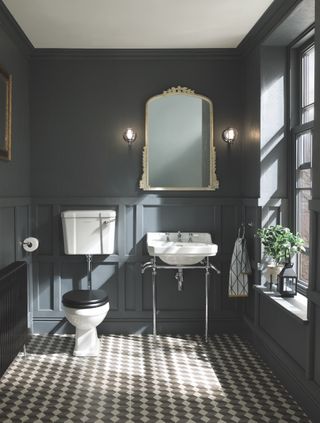 Powder room with dark grey walls and geometric heritage tiled floors by Bayswater Bathrooms