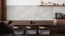 A dining area with banquette seating and wooden chairs beside a coffee bar