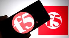 F5 logo and branding pictured on a smartphone screen held up in hand with company logo in background.
